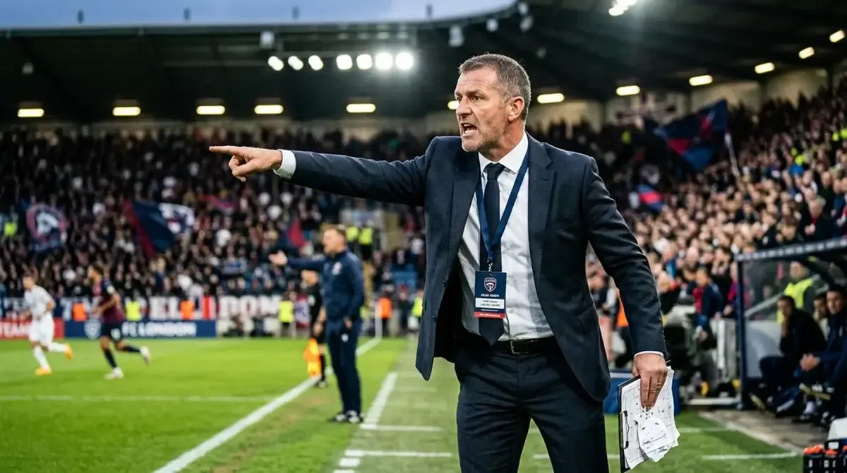 A football coach giving tactical instructions on the touchline during a World Cup match
