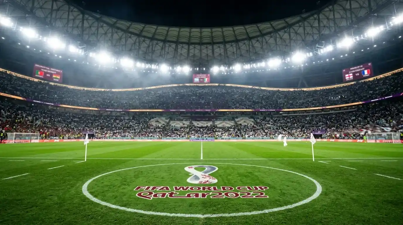 A football pitch under stadium floodlights with three illuminated match clocks counting down to kickoff